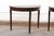 An Italian pair of wooden demi-lune console tables from the 19th century. These antique tables from Italy, embodying the...