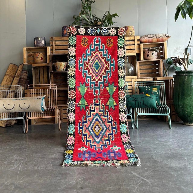 Immerse yourself in the rich tapestry of Moroccan culture with this exquisite Vintage Moroccan Berber Boucherouite Rug....