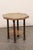 An Italian brass and wood, two-tier accent table from the early 20th century. This antique table from Italy has been...