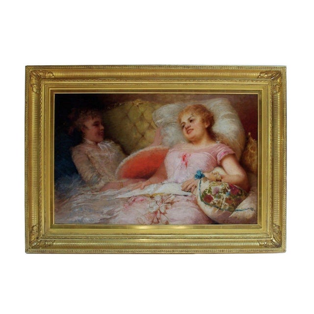 E. Zurbo, signed. Framed oil on canvas representing two women in a couch. The right one is dressed in sweet pink and...