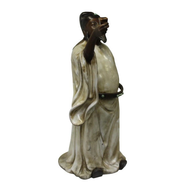 This is a Chinese decorative ceramic pottery figure of ancient oriental scholar old man with fine precise fingers and...