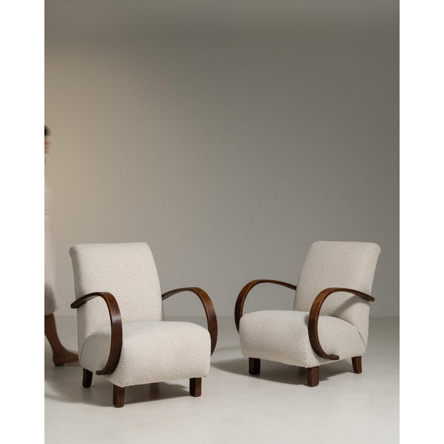 Here is a armchair, its cream boucle upholstery the first thing to catch the eye. Originating in France during 1950s, it...