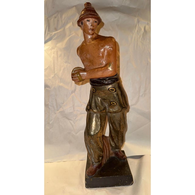 This listing is for a mid century ceramic sculpture of a male performer. The performer wears a hat and holds percussion...
