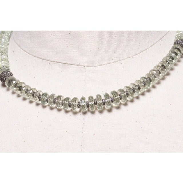 Faceted round prasiolite (green amethyst) beads with diamond rondelles in between and a pave`- set bead at each collarbone...