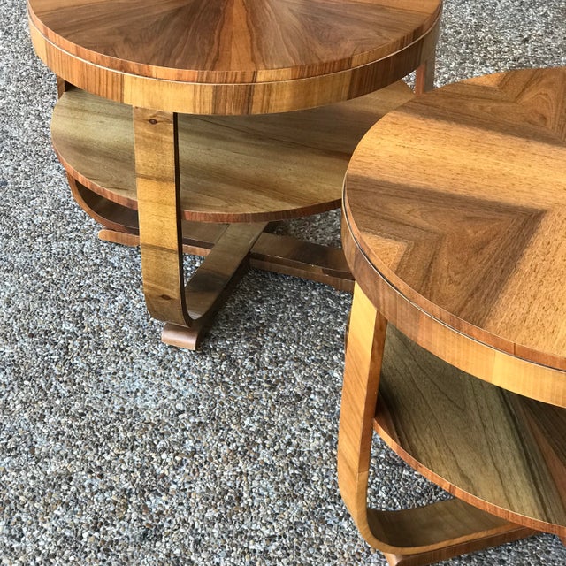 Set of two elegant Art Deco occasional tables in mixed woods. Two different veneer patterns on table tops. Round tops with...