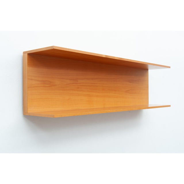 Cherry wood wall shelf for wall mounting with two hooks. Clean, functional design from the 1960s. Walter Wirz designed...