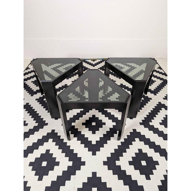Great little set of 3 ebonized triangular tables with smoked glass by Porada Arredi. Bottom of each table has tongue and...