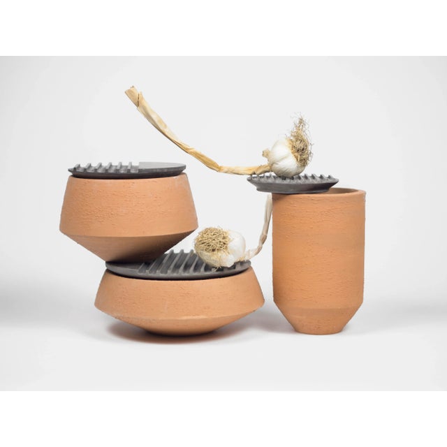 The lines across the lids of these pieces echo those drawn on the landscape seen from above - symbols of agricultural...