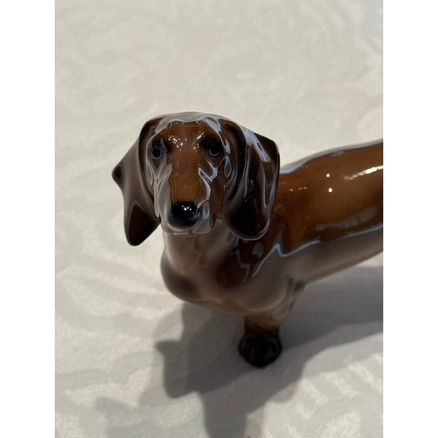 A stunning vintage mid-century modern German porcelain figurine of a smooth-haired Dachshund (Teckel), beautifully crafted...