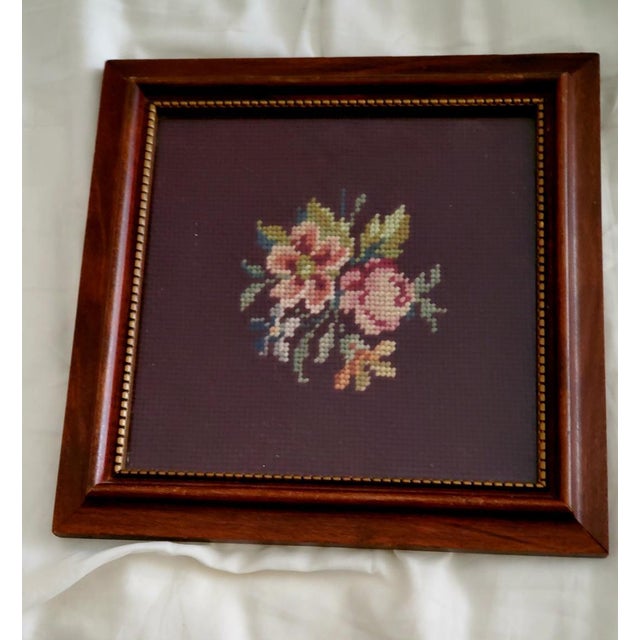 Beatiful and intricate handmade original vintage needlepoint of pink floral bouquet on a rich dark brown background....