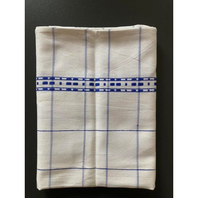 A beautiful blue and white folk hand-woven vintage linen napkin from Romania, circa mid 20th century, Europe. On a white...