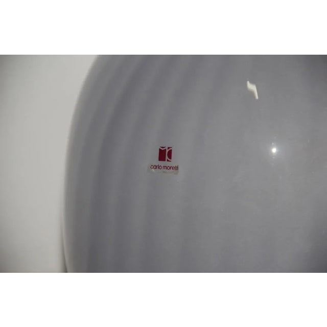 This particular lamp comes in the shape of a vase. It was designed by Carlo Moretti in the 1970s and is made of Murano art...