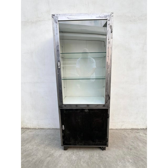 1960s German steel medical cabinet. Lockable glass display cabainet with 2 glass shelves & a lockable lower compartment...