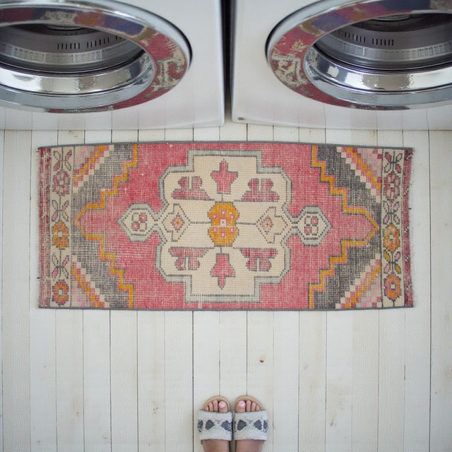 This charming hand-knotted Oushak rug brings a touch of Aegean warmth and vintage character to any space. Its petite...