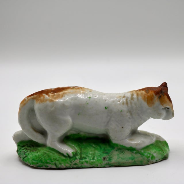 An exceptionally rare and charming early 19th-century English Staffordshire pearlware miniature pottery figurine of a...