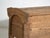 This antique primitive storage bench in wood is a bench with a chest, a lift-up seat and carved sides, of thick board. It...