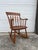 This antique petite rocking chair features hardwood construction, original maple finish, sculpted wood arms, turned frame...