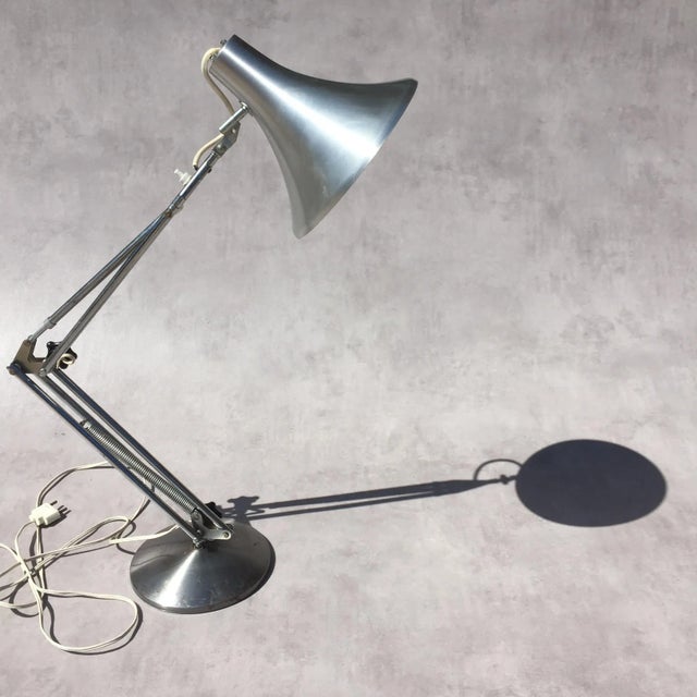 This vintage articulated desk lamp is from the 1960s. European Plug (up to 250V).The wiring of this item may be original...
