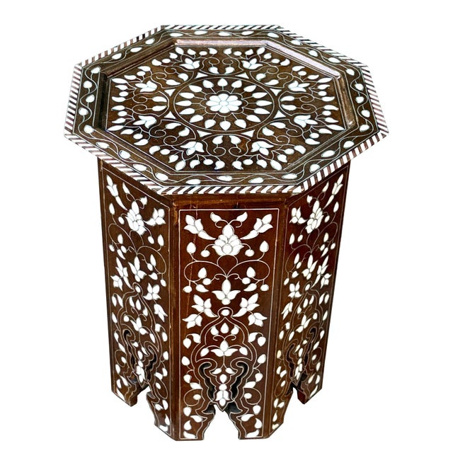 Beautiful Mother of pearl inlaid octagonal accent table. Floral pattern of natural shell with silver metallic wire.