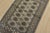 A tribal Bokhara rug hand-knotted with fine wool on a cotton foundation. This rug features rows of repeating medallions...