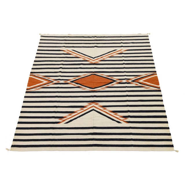 Enhance your space with this handmade Navajo-style wool rug, which beautifully blends traditional Southwestern heritage...