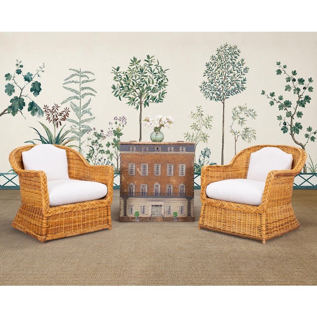 A stylish pair of 20th century organic modern lounge armchairs crafted out of woven wicker, rattan, and bamboo. The chairs...