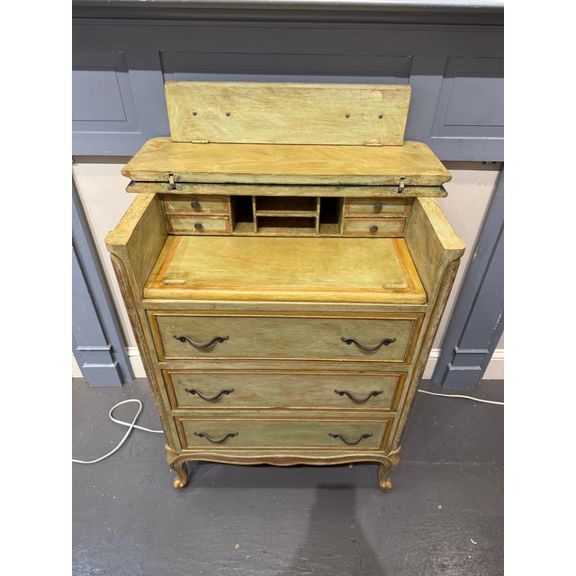 This is a 1940s French provincial fall front desk. It is hand painted. It has three drawers for storage. There is also...