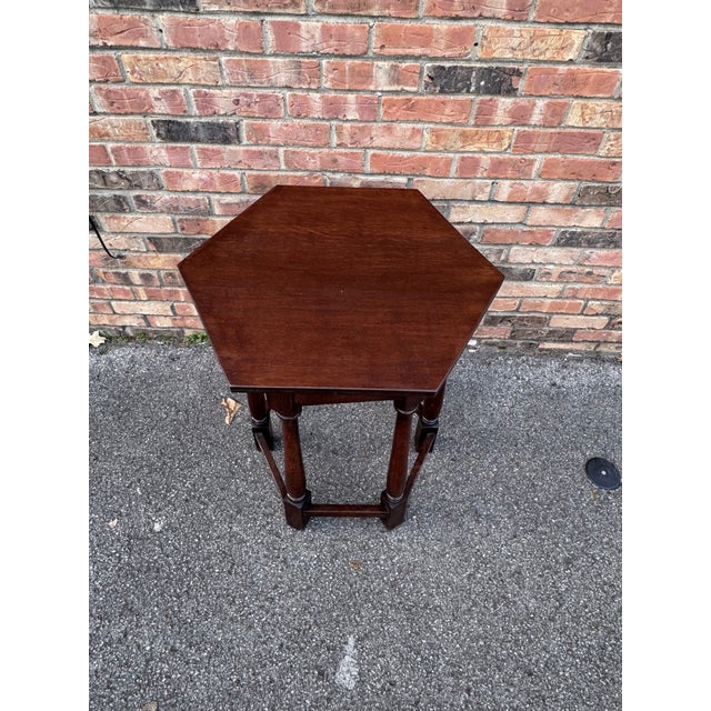 This hexagonal side table is very interesting. a tall, slim piece. at its smallest width, 21" and it's largest (point to...