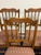 Beautiful set of six vintage dining chairs featuring warm, richly toned cherrywood frames, elegant turned spindle backs,...