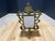 An ornate vintage tabletop picture frame cast in solid brass, designed in the classic Rococo / Baroque Revival style. The...