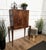 Beautiful 1950s Italian Art Deco bar cabinet in great wood veneer front double doors standing on four tapered legs giving...