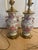 Listed is a pair of vintage Chinese export-style Famille Rose porcelain vase mounted lamps, featuring a pink color. These...