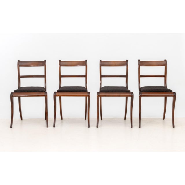 Set of Four Regency Style Mahogany Dining Chairs, with floral black upholstered seats. 32.5" H x 18" W x 17.5" D; seat:...