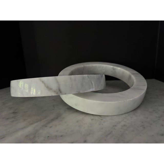 Very decorative pair of interlocking rings of white Carrera marble with pale grey veining. These look great on a cocktail...