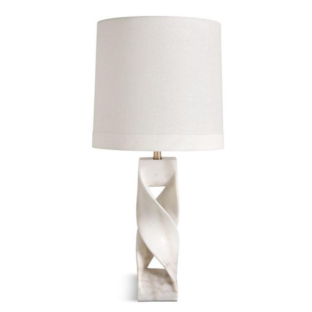 This elegant table lamp features hand-carved white marble that gracefully twists and intertwines, creating an airy,...
