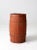 This is an antique primitive painted barrel. The rustic red wooden keg features wood slats and metal banding.