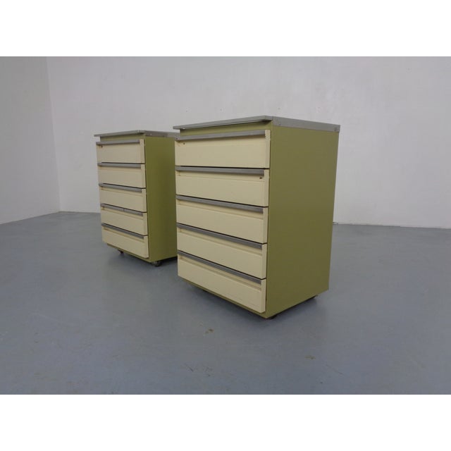 Pair of rolling steel doctor's chests, each with 5 drawers, by Baisch from the 1940s/1950s. Top surfaces with black glass...