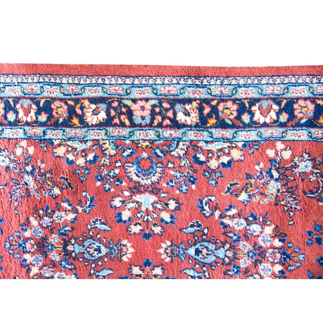 A wonderful mid-20th century Persian Sarouk runner with a repeated mirrored floral pattern running across the length of...