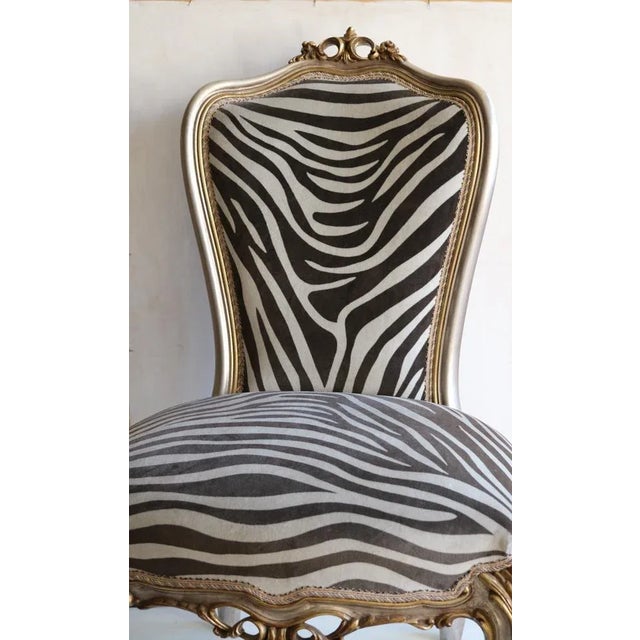 Hand -carved wooden armchair, handcrafted produced in the 1950s in Lombardy. Gold and silver leaf silver. Upholite and...