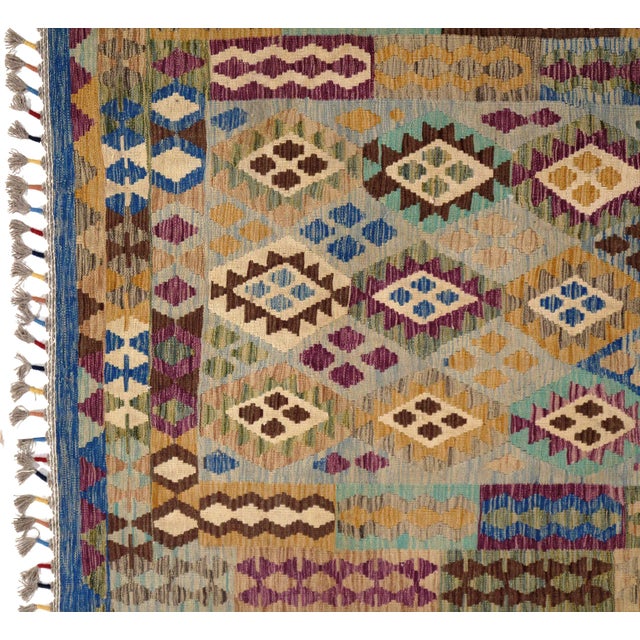 Add a touch of elegance to your home with this casual chic hand woven Kilim wool rug. Constructed on a loom by Nomad...