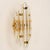 Pair of Murano glass wall sconces featuring five long crystal clear glass "triete" prism-rods, with gold-plated details...