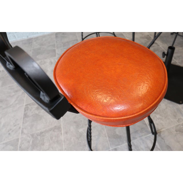 Vintage Spanish Revival Wrought Iron Swivel Bar Stool Set With Matching Mesh Bar Table & Heavy Umbrella Stand – Mid-Century, Orange Vinyl For Sale - Image 4 of 12