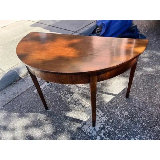This is a very nice pair of English console tables from the late 18th century, featuring a George III mahogany design....