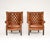 An outstanding pair of antique leather barrel back wing armchairs. They were made in England and date from the early...