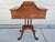 A unique mahogany side table having a central tabletop with tray lip and two flip top panels to access interior storage....