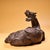 This striking antique gilt bronze sculpture depicts a recumbent mythical beast, possibly a Qilin or a similar guardian...