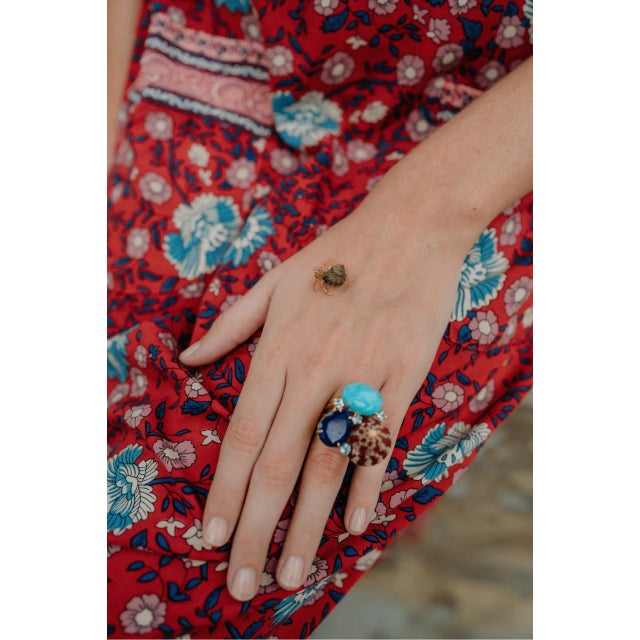The Natasha Ring is a mesmerizing creation, featuring semi-precious stones arranged in a cluster with sea shell and...
