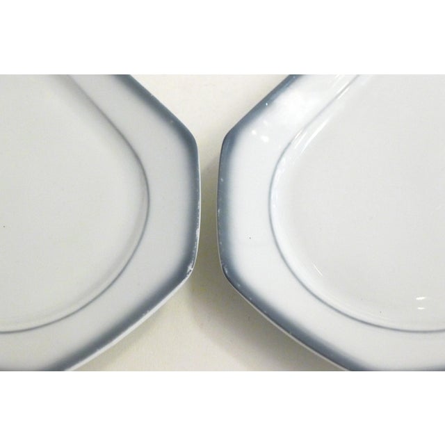 Two small elongated octagonal dishes, white porcelain with double edging gray bluish / blurred Stamp of the factory...
