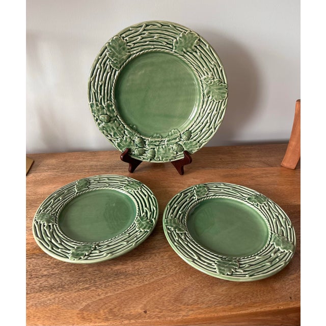 A gorgeous green group in the Oak Leaf pattern from Bordallo Pinheiro. The large chop plate features a raised twig and...