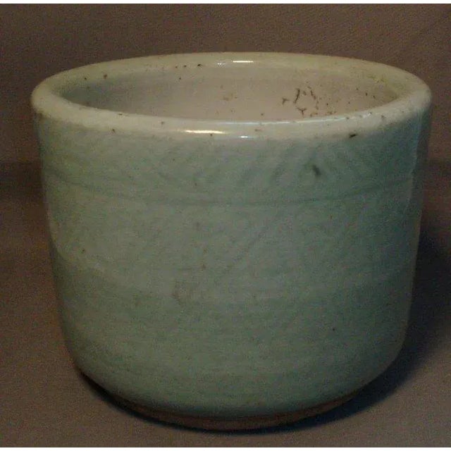A fine celadon censer or brush pot with incised geometric decoration throughout. Heavily potted with nice foot. Has a...